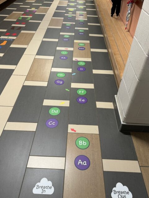 Colorful sensory path with alphabet and breathing exercises for children.