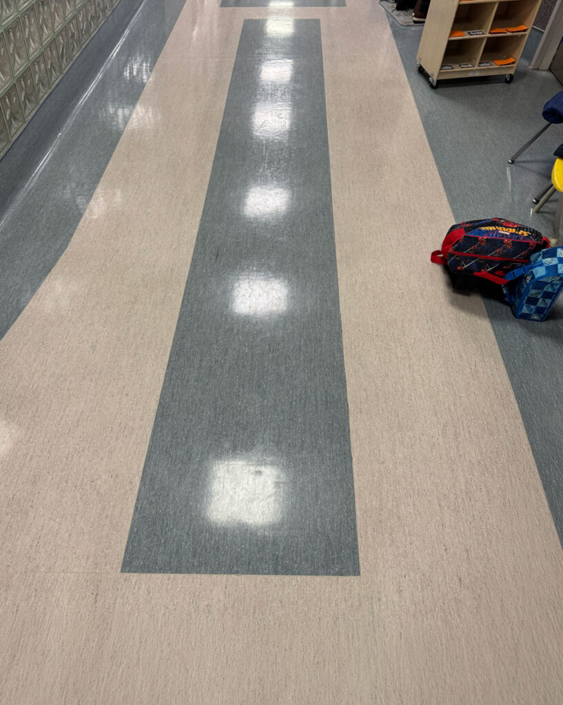 Colorful sensory path on school hallway floor for children.