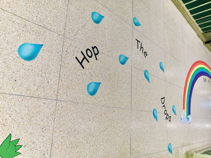 Colorful sensory path with water drop decals and rainbow design for children.