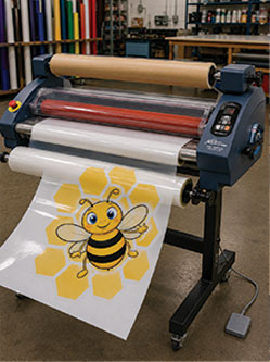 Printing machine creating colorful sensory path designs for children.