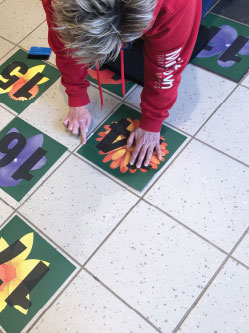 Child engaging with sensory path tiles for sensory play and development.