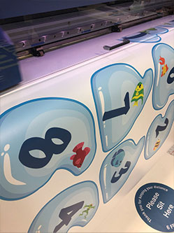 Colorful sensory path tiles with numbers and animals for children.